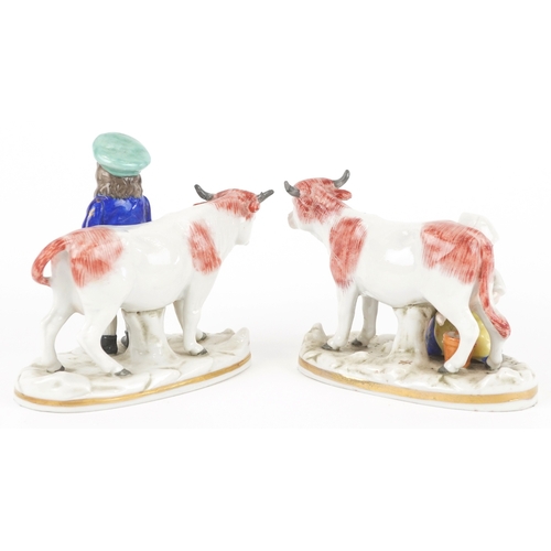  A pair of continental hand painted porcelain figures of children with cows, the largest 9.5cm high.