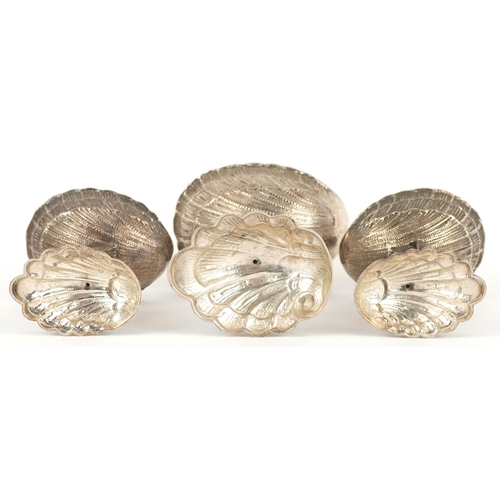  xxx side view xx Three silver open salts cast as Putti riding dolphins, with shell design bowls, the... 