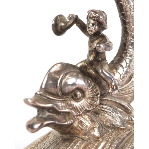  xxx side view xx Three silver open salts cast as Putti riding dolphins, with shell design bowls, the... 