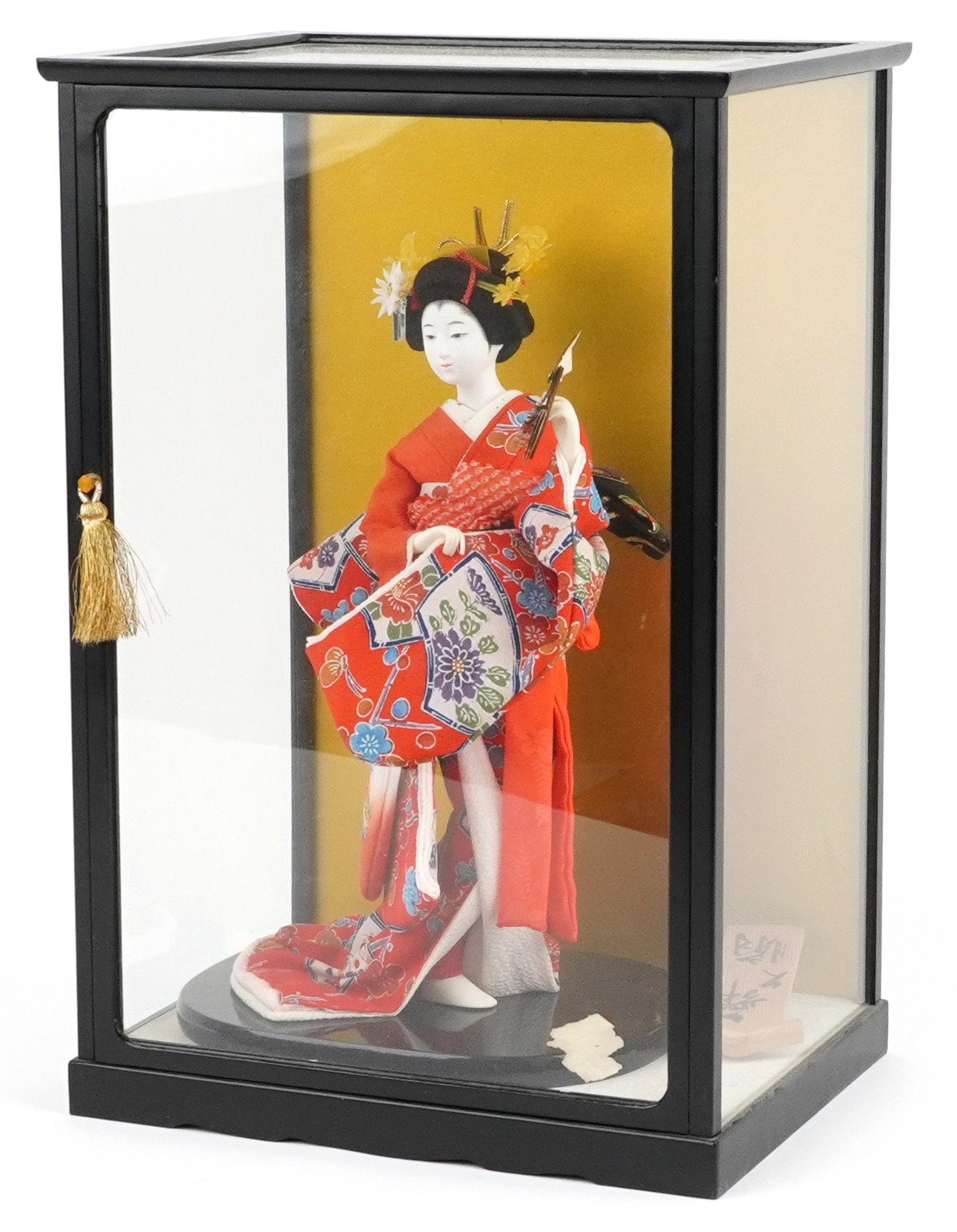 A Chinese figure of a Geisha mounted on an ebonised base within a ...