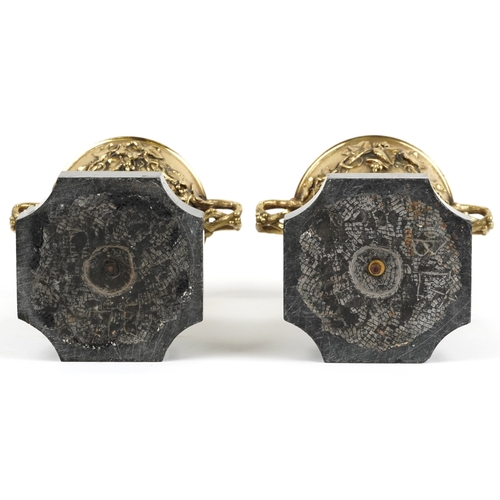50 - A pair of 19th century bronze twin handled urns decorated in relief with swags of vines and berries,... 