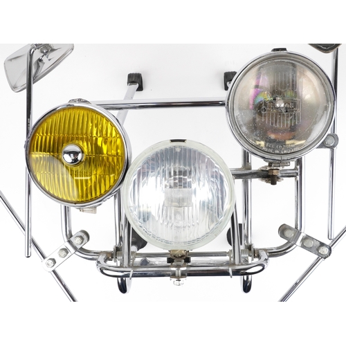 A chromed scooter front rack fitted with spotlights and mirrors ...