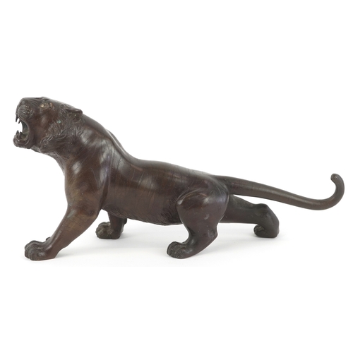  A Japanese bronze okimono figure of a tiger bearing signature to the base, 30cm in length.