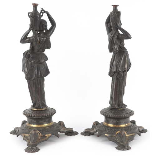 49 - A pair of 19th century bronze candelabra figural bases, each modelled as a maiden carrying a jar, ra... 