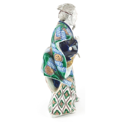  A Japanese Kutani hand painted porcelain figure modelled as a Samurai, 20th century, 30cm high.