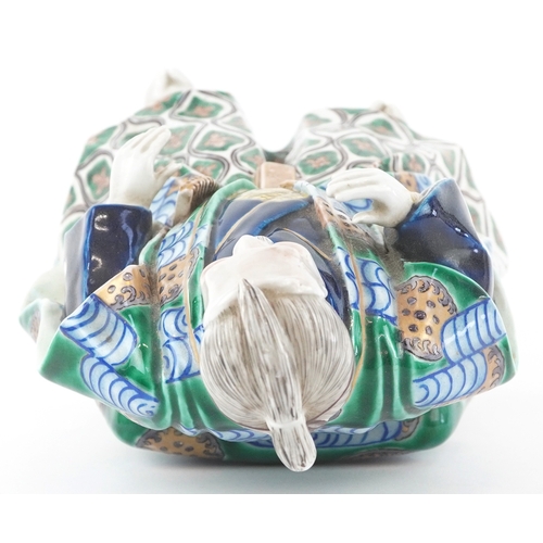  A Japanese Kutani hand painted porcelain figure modelled as a Samurai, 20th century, 30cm high.