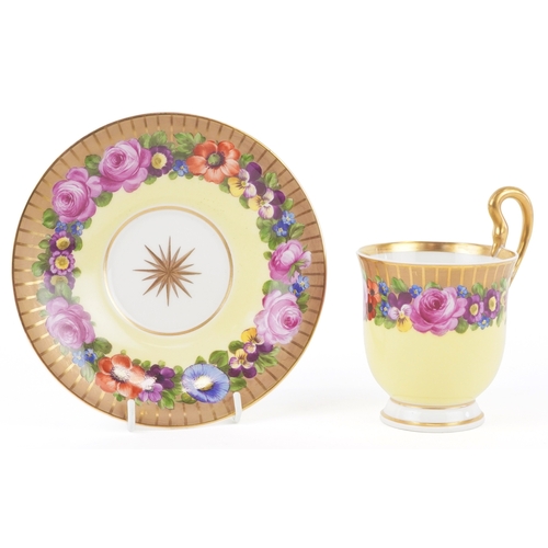  A 19th century Berlin porcelain cabinet cup and saucer hand painted with floral decoration, bearing ... 