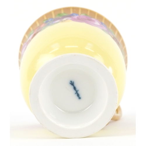  A 19th century Berlin porcelain cabinet cup and saucer hand painted with floral decoration, bearing ... 