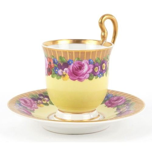  A 19th century Berlin porcelain cabinet cup and saucer hand painted with floral decoration, bearing ... 