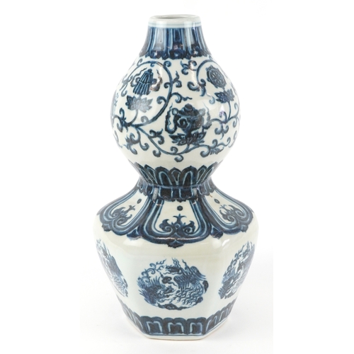 122 - A Chinese blue and white porcelain double gourd vase hand painted with flower heads and mythical ani... 