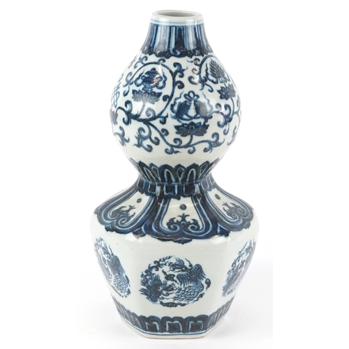 122 - A Chinese blue and white porcelain double gourd vase hand painted with flower heads and mythical ani... 