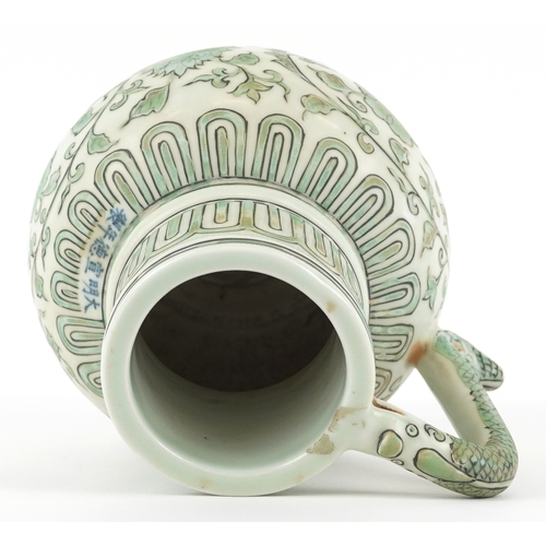 164 - A Chinese porcelain ewer with fish handle, hand painted with flower heads and scrolling vines, six f... 