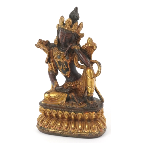 133 - A Chino Tibetan gilt bronze figure of a seated Buddha, 18cm high.