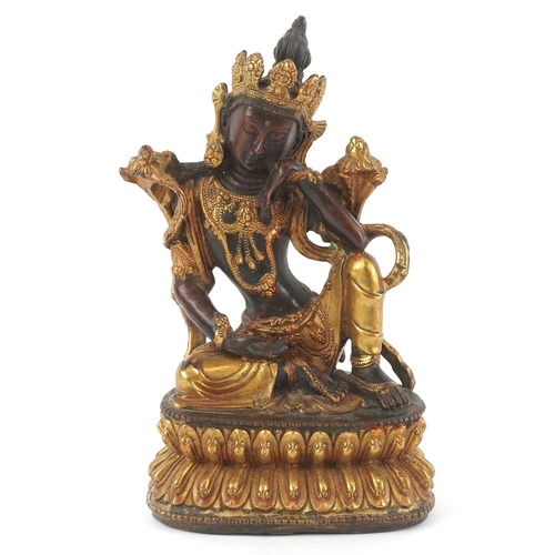 133 - A Chino Tibetan gilt bronze figure of a seated Buddha, 18cm high.