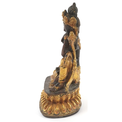 133 - A Chino Tibetan gilt bronze figure of a seated Buddha, 18cm high.