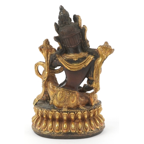 133 - A Chino Tibetan gilt bronze figure of a seated Buddha, 18cm high.