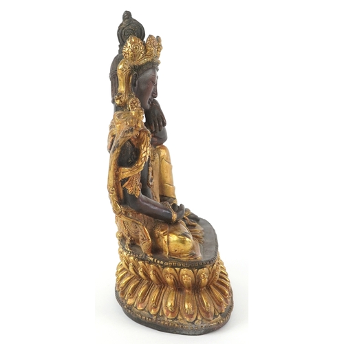 133 - A Chino Tibetan gilt bronze figure of a seated Buddha, 18cm high.