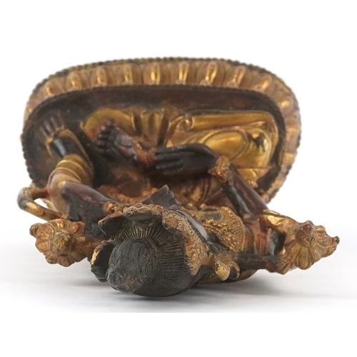 133 - A Chino Tibetan gilt bronze figure of a seated Buddha, 18cm high.