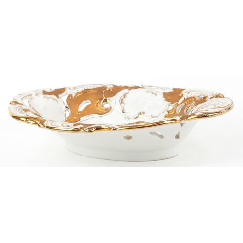 32 - A Meissen porcelain gilded and pierced oval centrepiece bowl with hand painted floral decoration, be... 