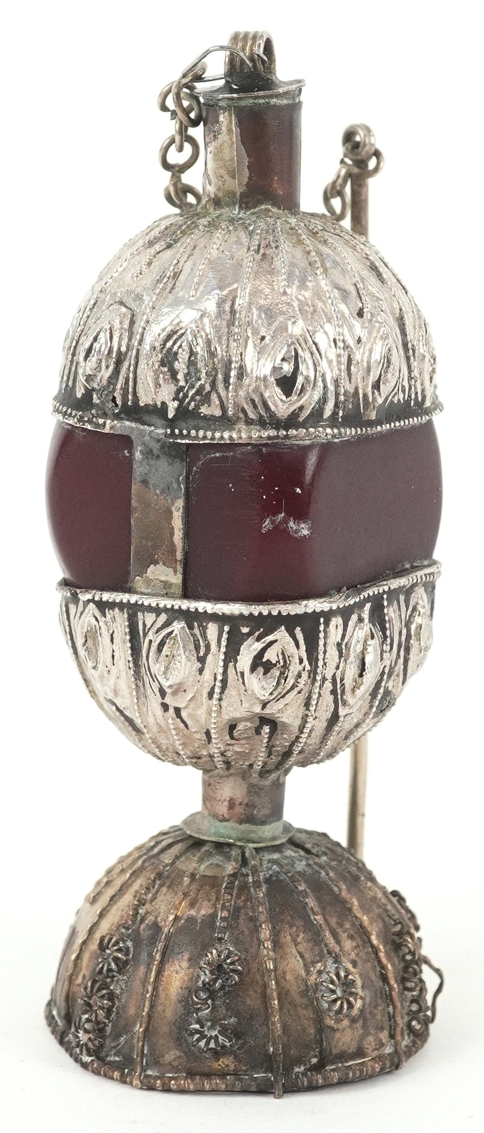 A Middle Eastern white metal and amber coloured kohl pot, indistinct ...