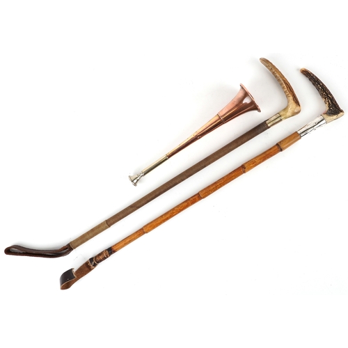 Two vintage horn handled riding crops, one with silver collar together ...
