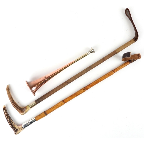 Two vintage horn handled riding crops, one with silver collar together ...