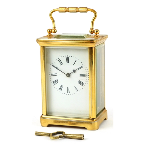 156 - A brass cased carriage clock having bevelled glass with enamelled dial and Roman numerals, 11cm high... 