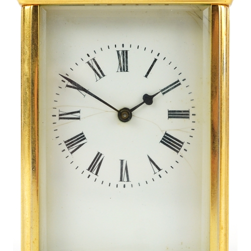 156 - A brass cased carriage clock having bevelled glass with enamelled dial and Roman numerals, 11cm high... 