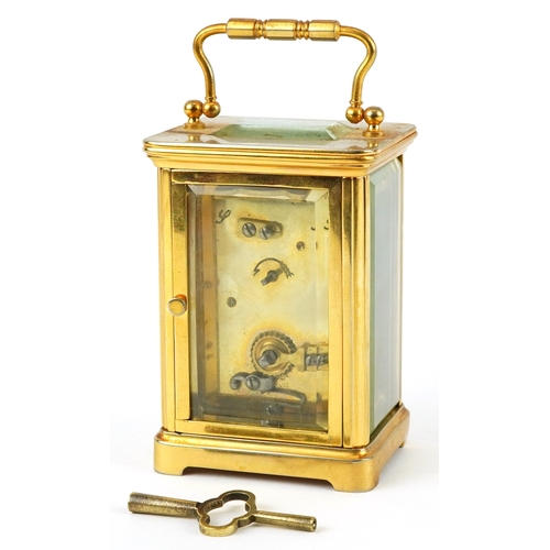 156 - A brass cased carriage clock having bevelled glass with enamelled dial and Roman numerals, 11cm high... 