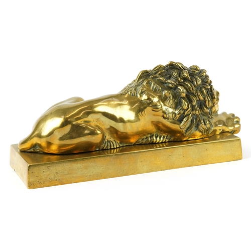 51 - A Grand Tour style gilt bronze study of a recumbent lion, 22cm in length.