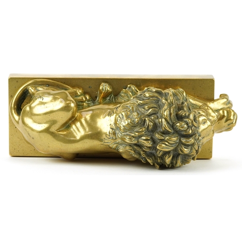 51 - A Grand Tour style gilt bronze study of a recumbent lion, 22cm in length.