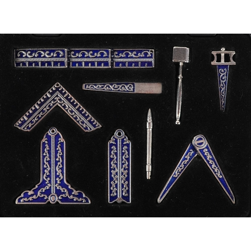 A cased set of miniature masonic working tools, the case 10cm wide.