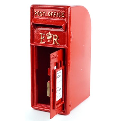 A red painted post box with cast iron front, 60cm high.