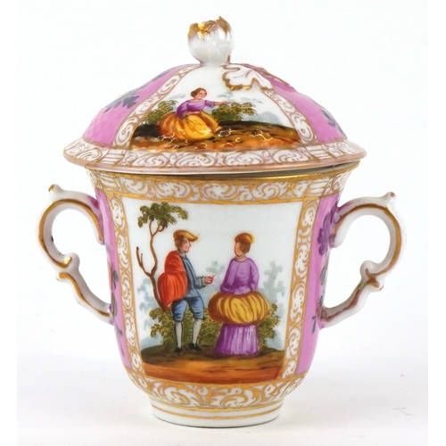 36 - A 19th century porcelain twin handled chocolate cup and cover hand painted with panels depicting a c... 