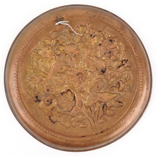 17 - A Victorian aesthetic copper charger embossed with birds amongst foliage, 37cm in diameter.