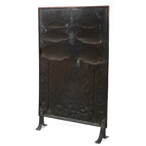 7 - A 19th century Arts & Crafts copper firescreen embossed with a sunrise and stylized trees, 86cm high... 