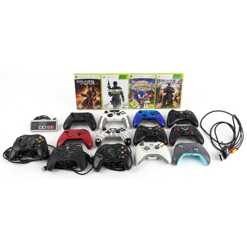 A selection of games console controllers, predominantly Xbox, together ...