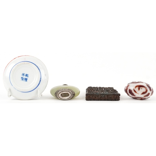 137 - A Chinese green stone snuff bottle with silver plated mounts together with a carved boxwood card cas... 