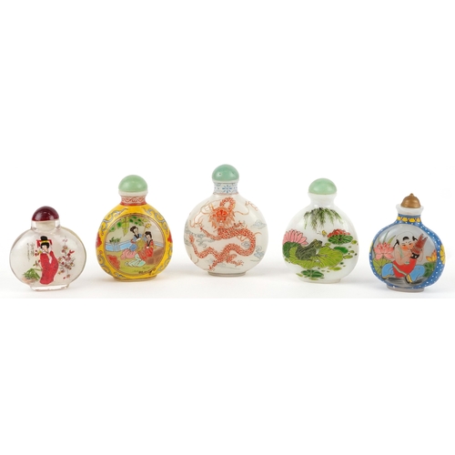 135 - Five Chinese glass snuff bottles and stoppers, each with hand painted decoration including dragons a... 