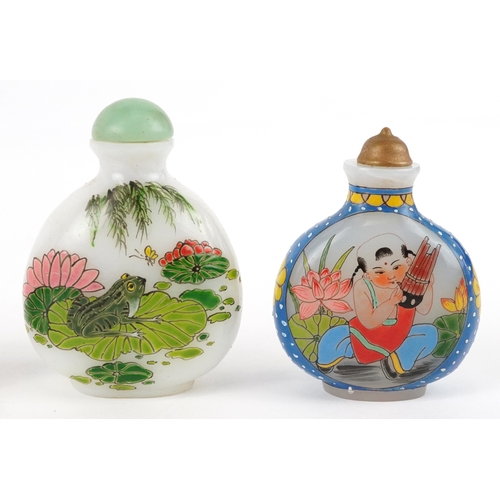 135 - Five Chinese glass snuff bottles and stoppers, each with hand painted decoration including dragons a... 
