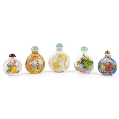 135 - Five Chinese glass snuff bottles and stoppers, each with hand painted decoration including dragons a... 