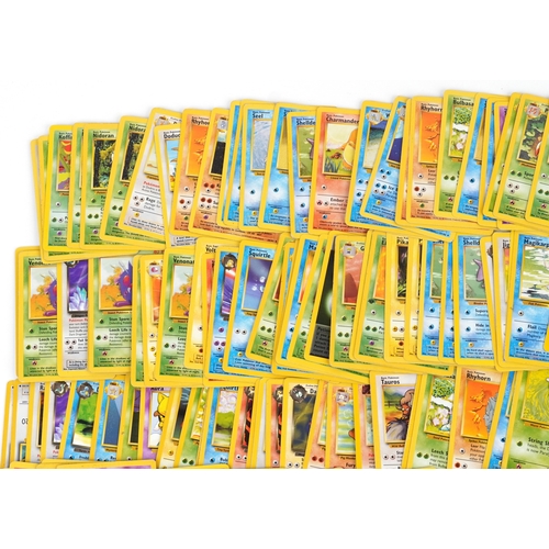 A collection of Pokmon trade cards including original base set cards, Fossil  set, Jungle set and Da