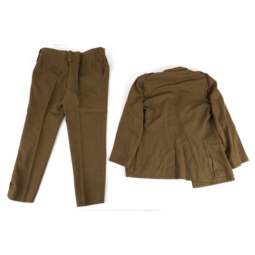 743 - A collection of military interest uniforms, paperwork, cap badges, hats and other militaria includin... 