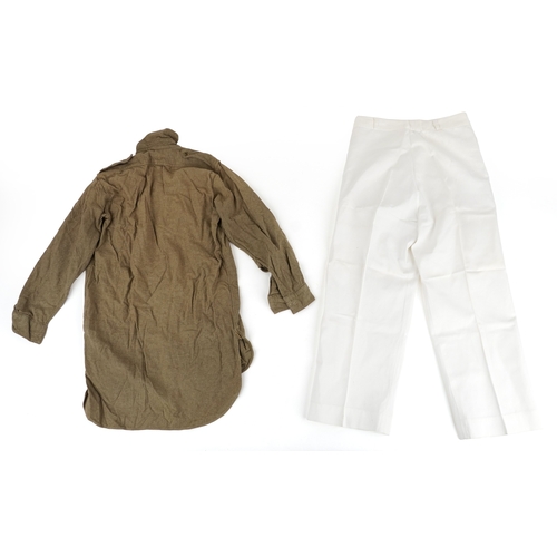 743 - A collection of military interest uniforms, paperwork, cap badges, hats and other militaria includin... 