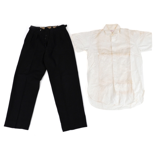 743 - A collection of military interest uniforms, paperwork, cap badges, hats and other militaria includin... 