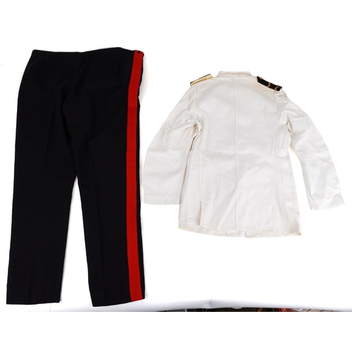 743 - A collection of military interest uniforms, paperwork, cap badges, hats and other militaria includin... 