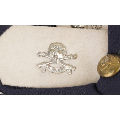 743 - A collection of military interest uniforms, paperwork, cap badges, hats and other militaria includin... 