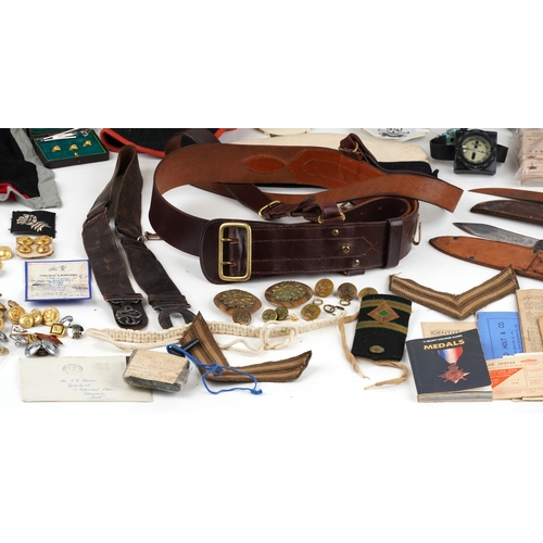 743 - A collection of military interest uniforms, paperwork, cap badges, hats and other militaria includin... 