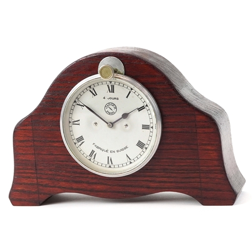 702 - Jaeger of Paris, a vintage car clock mounted in an oak stand, 19cm wide.