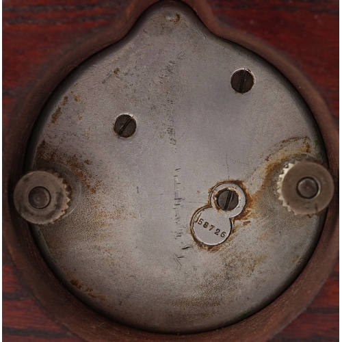 702 - Jaeger of Paris, a vintage car clock mounted in an oak stand, 19cm wide.
